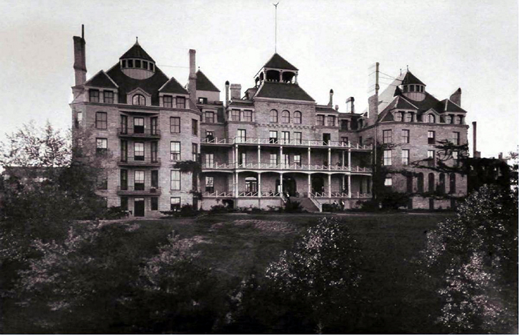 A period photograph of the Crescent Hotel's grounds and building facade, around 1890, showing the same three towers and wraparound porches as the 1886 photograph.