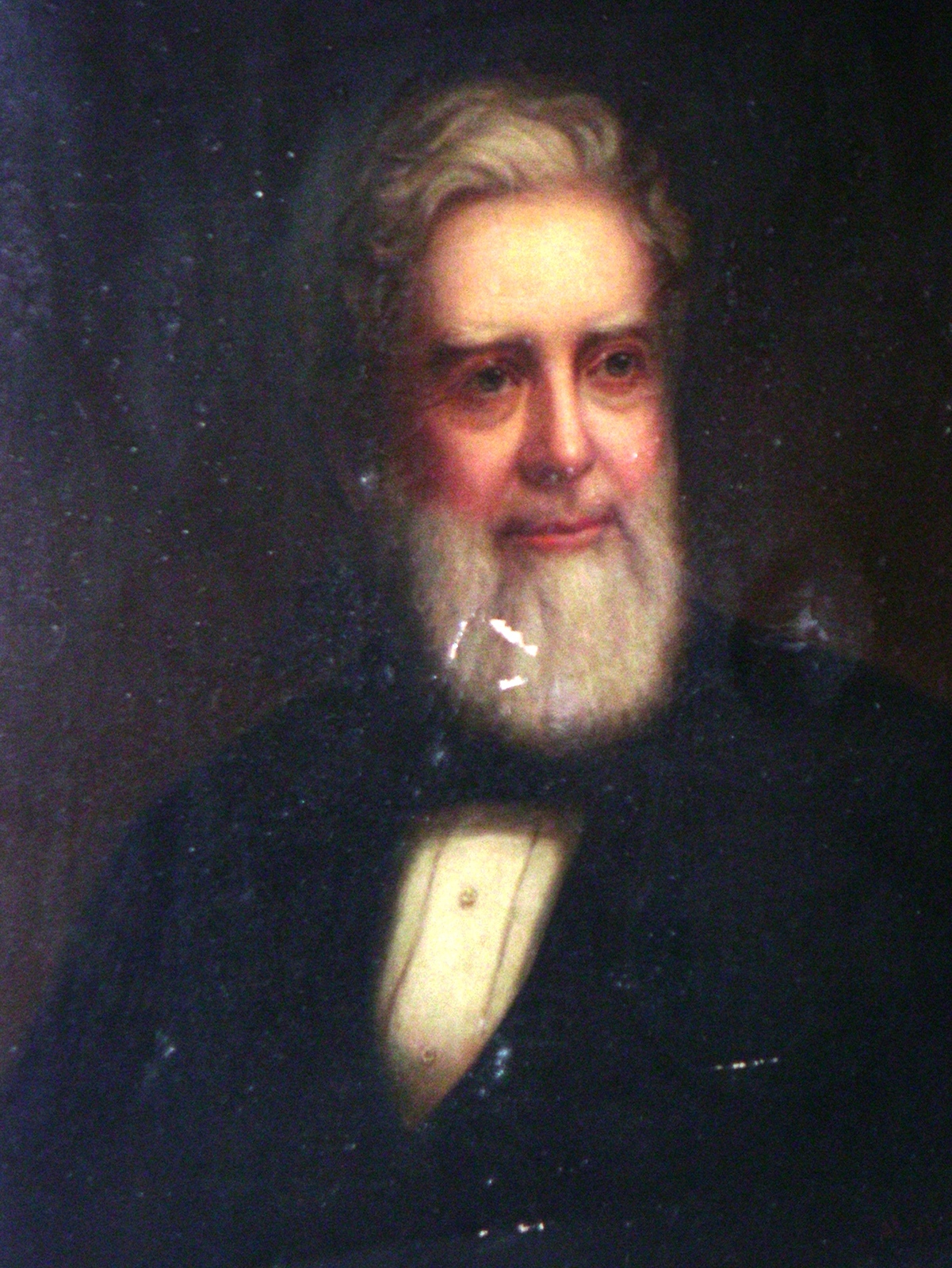 Oil portrait of an elderly white-bearded man in a dark coat with a light-colored waistcoat and bow tie, head and shoulders, against a dark background