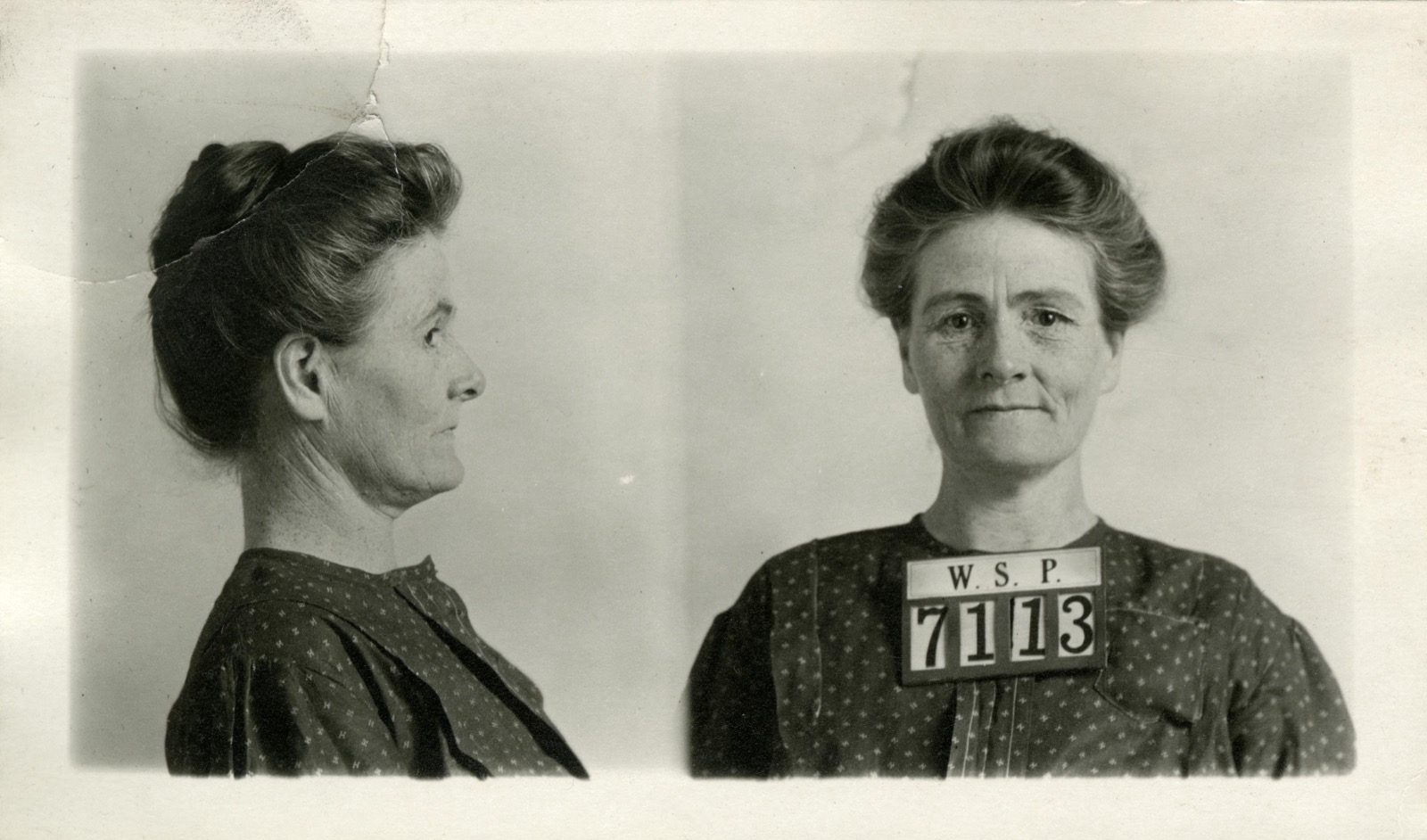 Two-panel penitentiary mug shot, left profile and front view, of a woman in a patterned dress with her hair up, wearing a placard reading 'W.S.P. 7113'; captioned as Linda Burfield Hazzard, 1913.