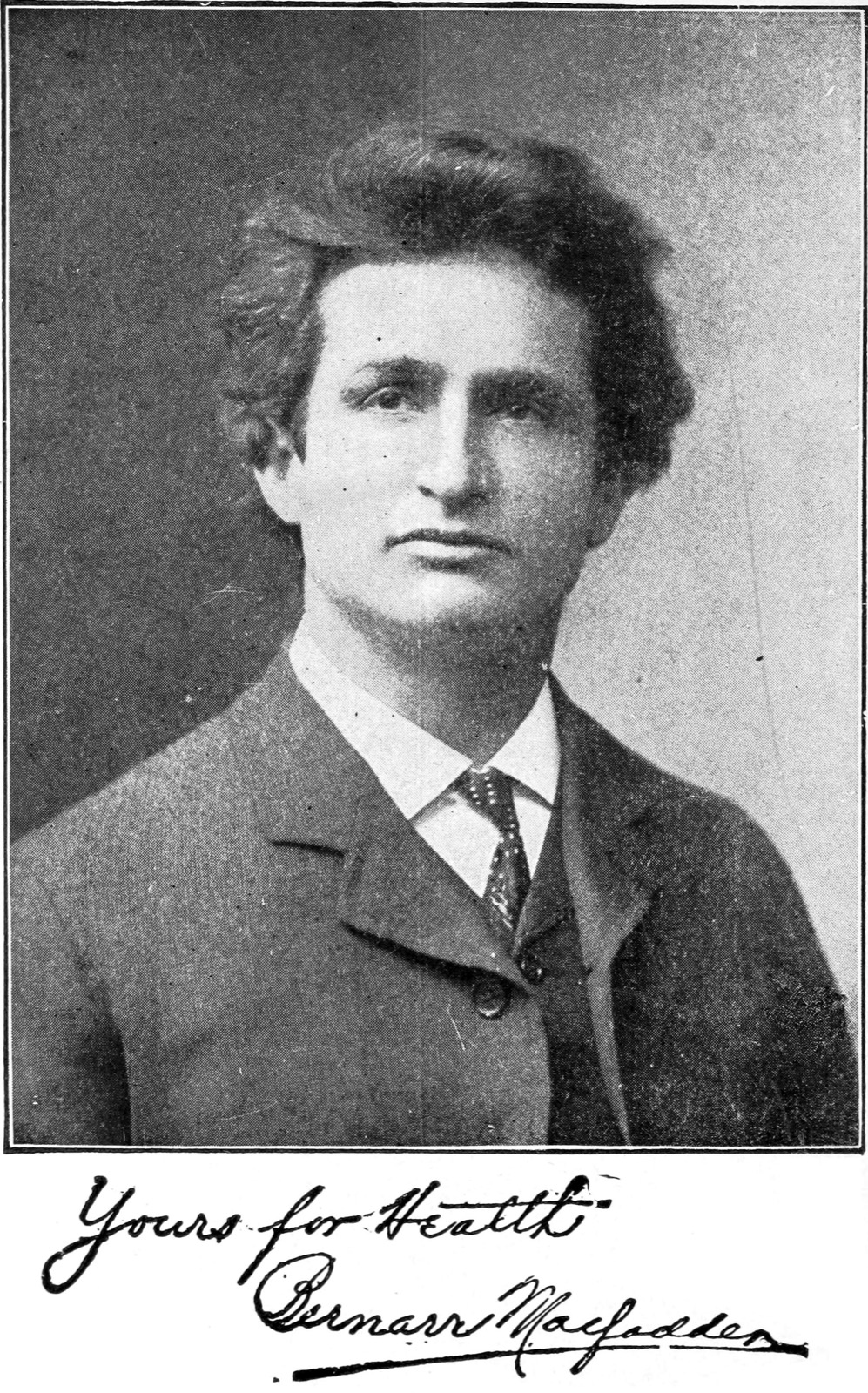 Sepia head-and-shoulders portrait of a young man in a suit and tie, with a handwritten inscription reading 'Yours for Health, Bernarr Macfadden' beneath it.